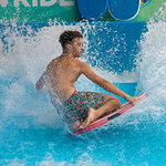 Teen splashing in wave rider at Massanutten Indoor WaterPark