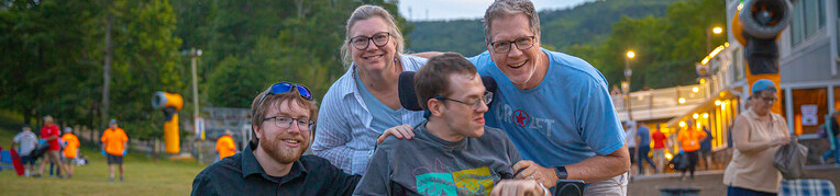 A family of four guests enjoying live music at a festival