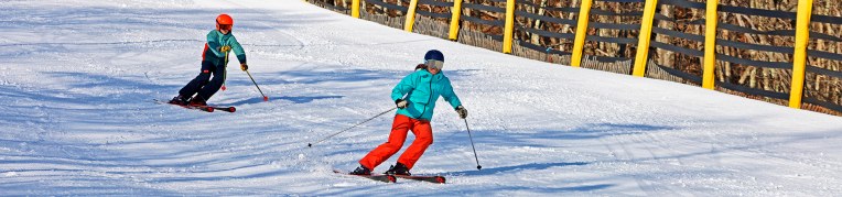 A mother and son skiing on the Massanutten Ski Slopes