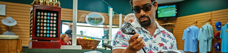 A man shopping at the Woodstone Meadows Golf Pro Shop at Massanutten Resort
