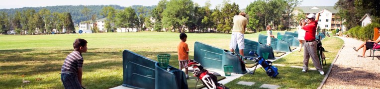 Five golfers taking a golf lesson at Massanutten Resort