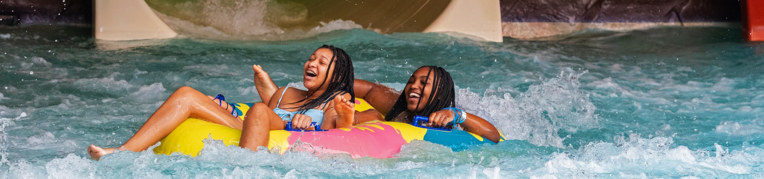 Two women on an inner tube at the Massanutten Indoor WaterPark