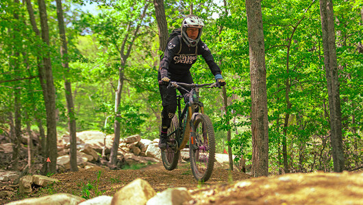 A guest riding a mountain bike at the Bike Park