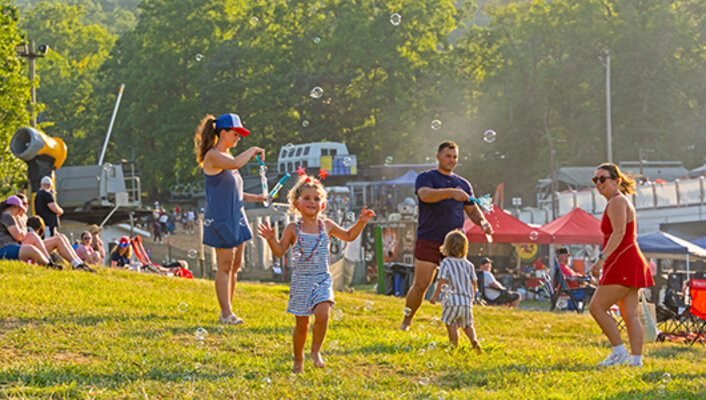 A family playing with bubbles outside on Massanutten Mountain