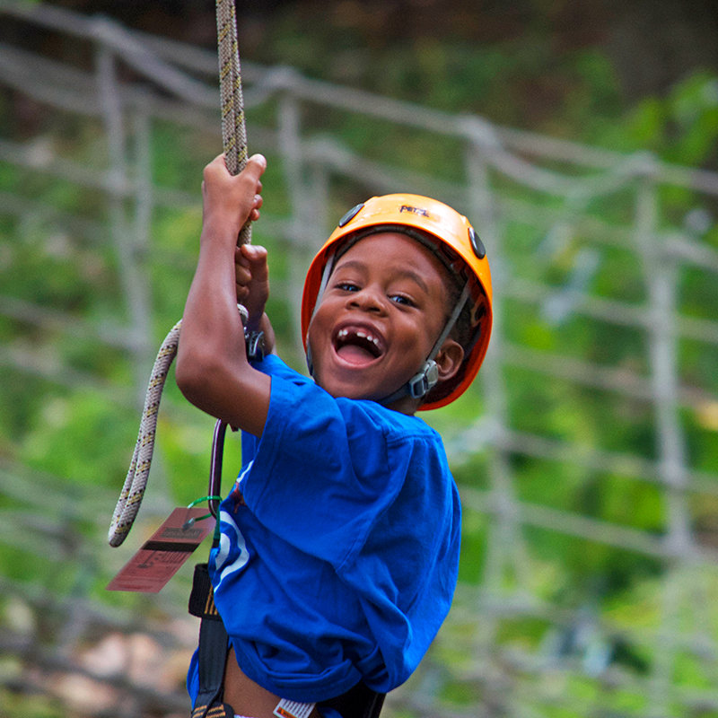 A boy riding a zipline at the Family Adventure Park