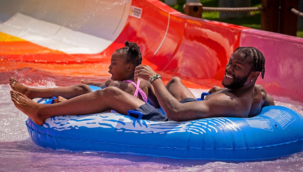 A man and girl on the water slide at the Massanutten Outdoor WaterPark