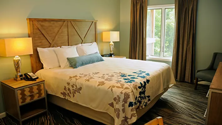 Interior photo of Woodstone Meadows condo king bed in primary bedroom