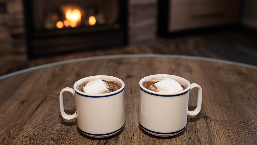Two mugs of hot chocolate in a Woodstone condo