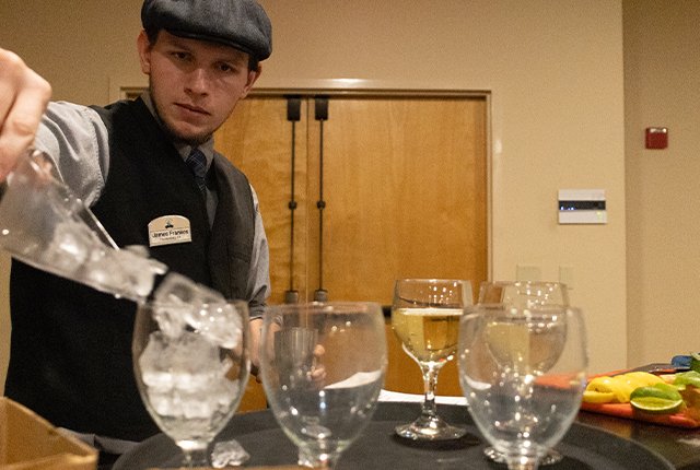 Employee pouring a beverage