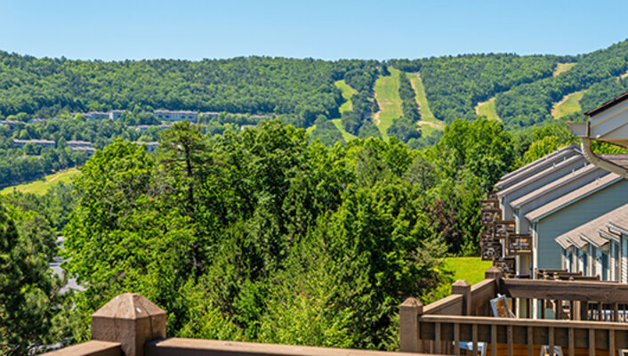 A view of condos and mountains from a balony